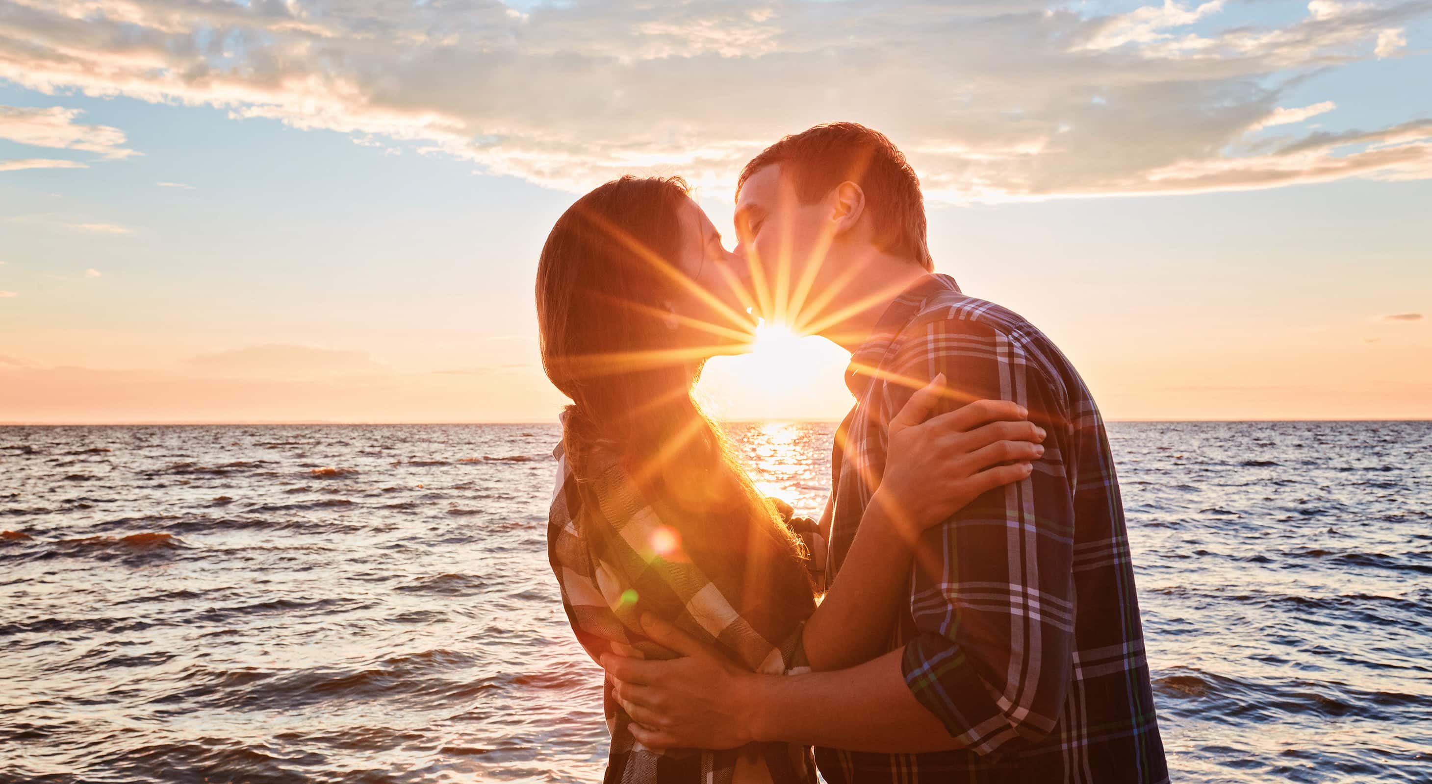 romantic couple kissing by the ocean in Falmouth MA