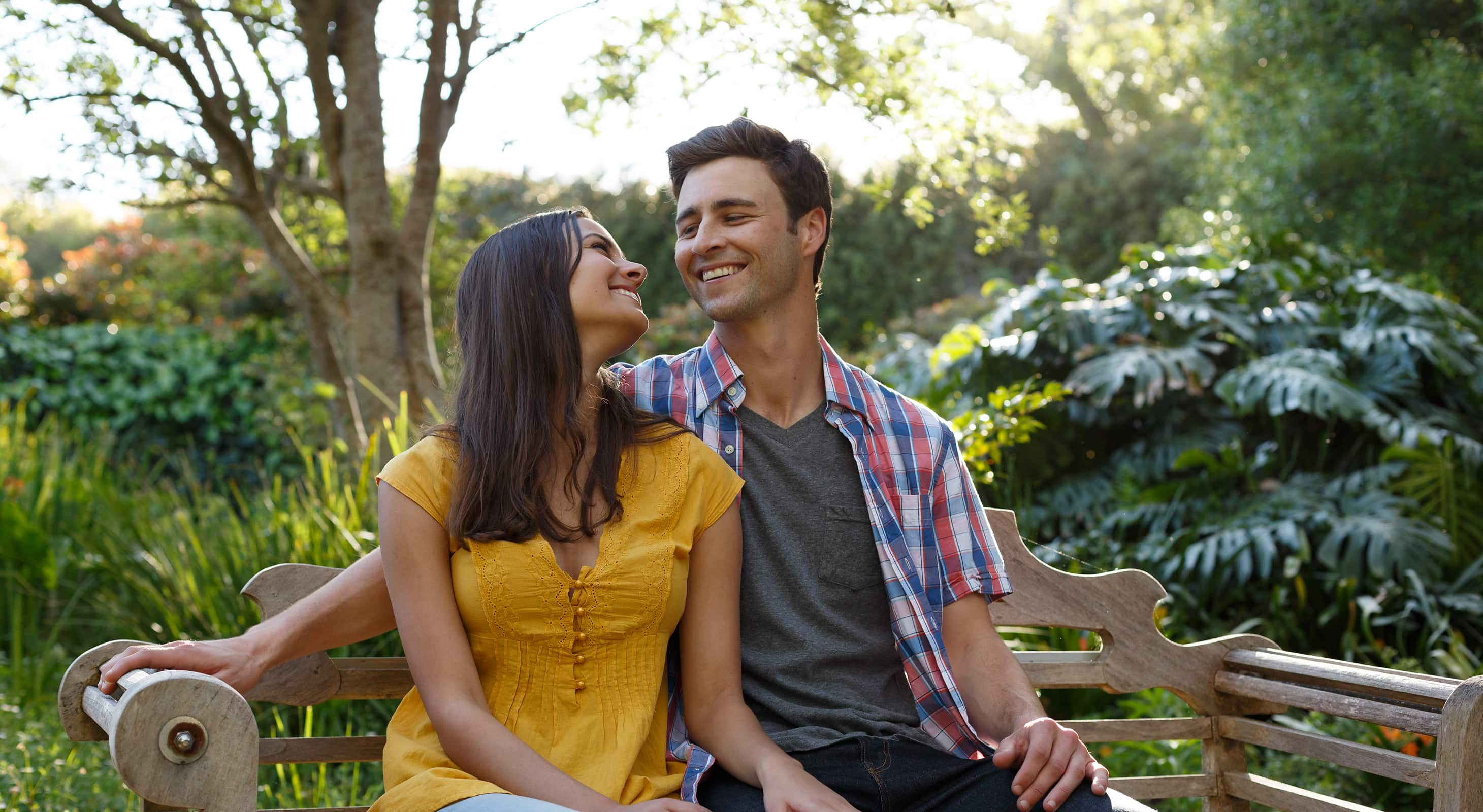 happy couple sitting on a bench