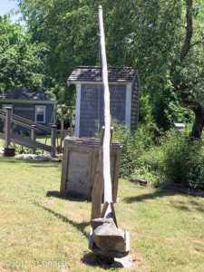 The well, where all of the water was drawn. Notice the leveraged pole with the stone as a counterweight. The Josiah Dennis Manse Museum on Cape Cod, New England, USA.