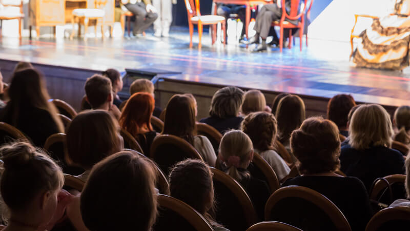 Back of a crowd wathing live theater