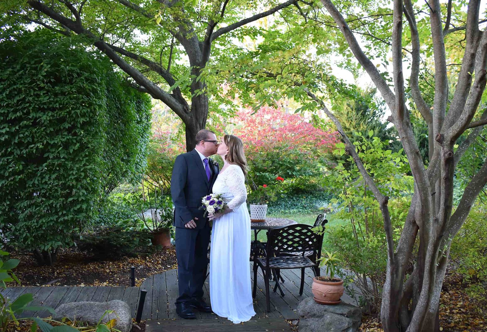 Bride and groom kissing in the round garden during a Cape Cod elopement