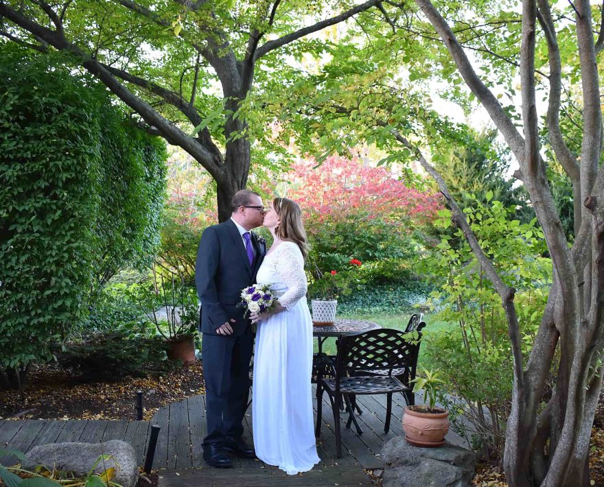 Bride and groom kissing in the round garden during a Cape Cod elopement