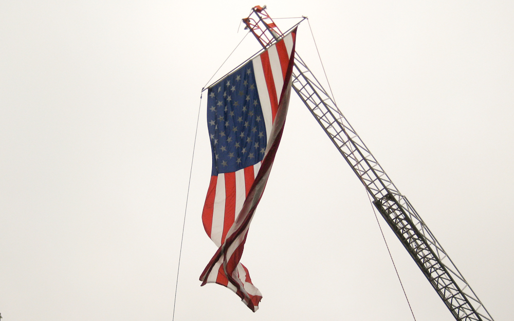 US Flag hanging from a crane for Memorial Day Weekend on Cape Cod