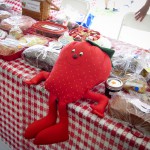 Smiling strawberry toy on a table at the Strawberry Festival 2012.