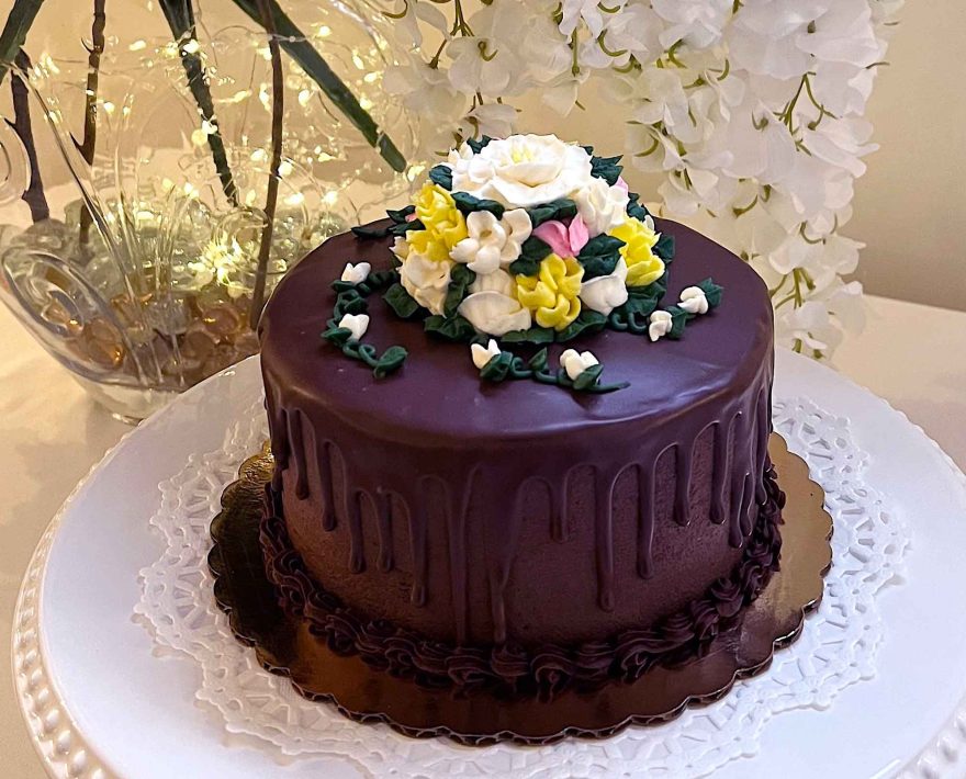 Chocolate wedding cake decorated with icing flowers