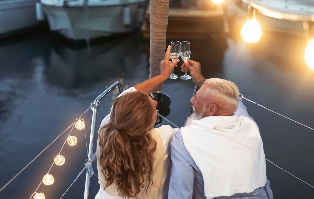 Couple toasting Champagne on a sailboat