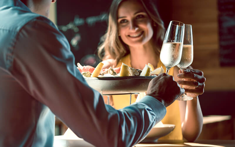 Couple at seafood dinner with champagne