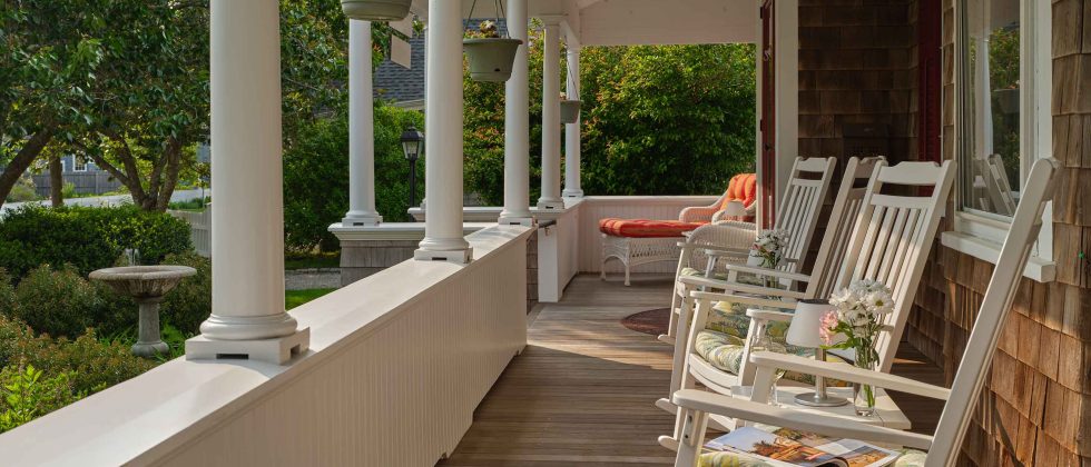 Front porch with columns and rocking chairs