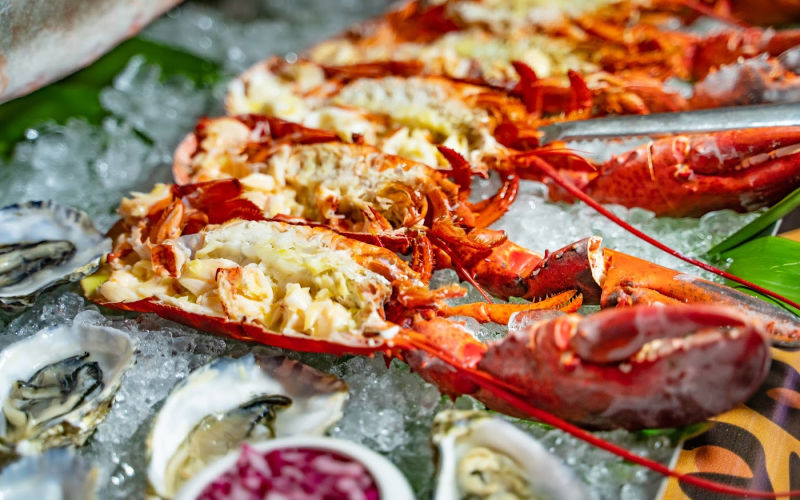 Half lobsters on ice with other shellfish