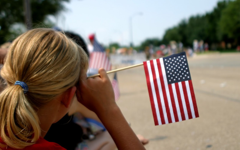 a woman with an american flag at a parade