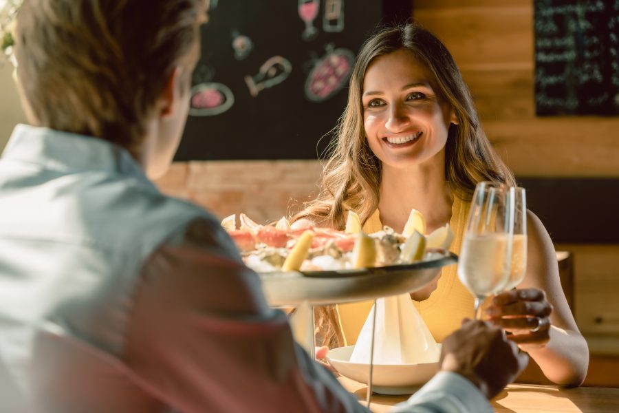 couple eating seafood with champagne