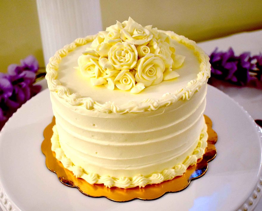 Wedding cake surrounded by purple flowers