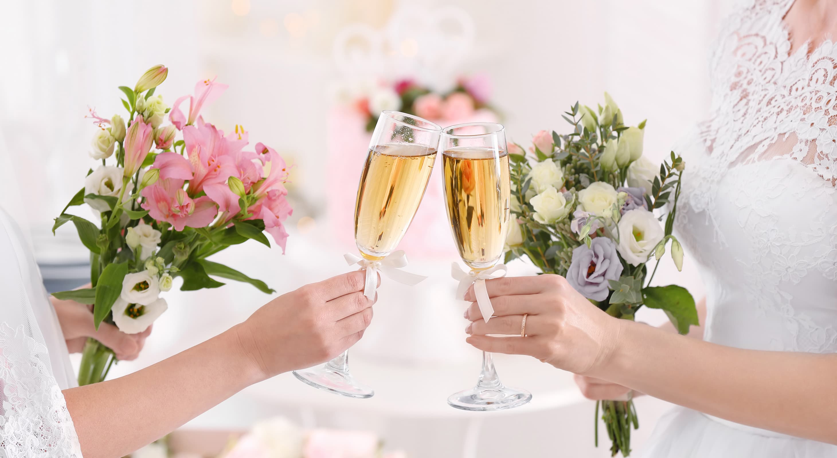 brides holding champagne and bouquets