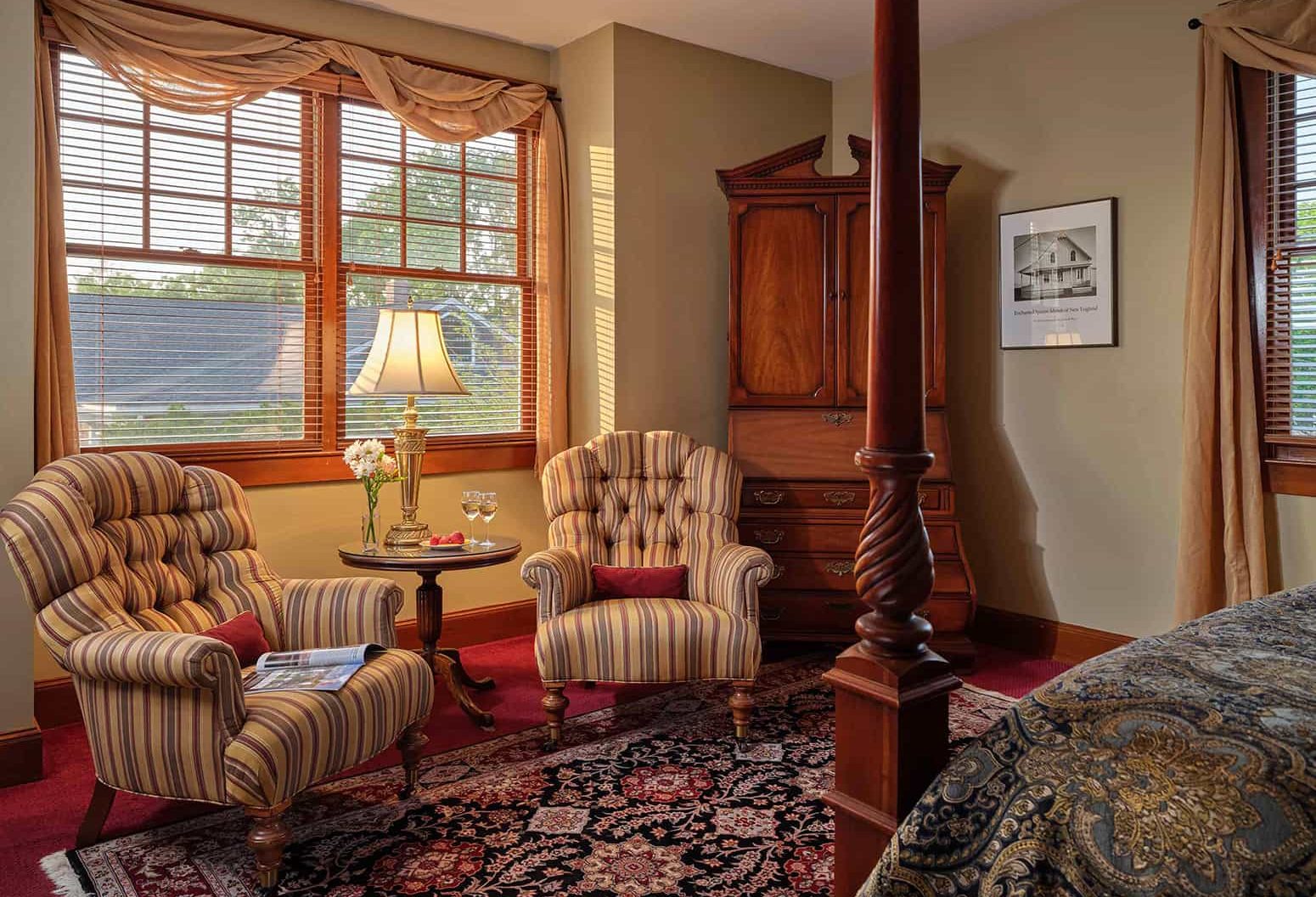 Elegant sitting area in Victorian guest room with wood windows