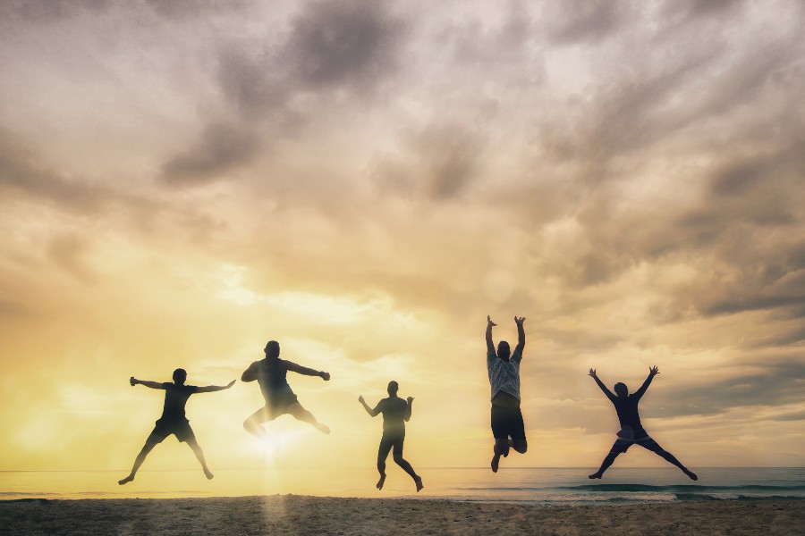 happy group jumping on beach