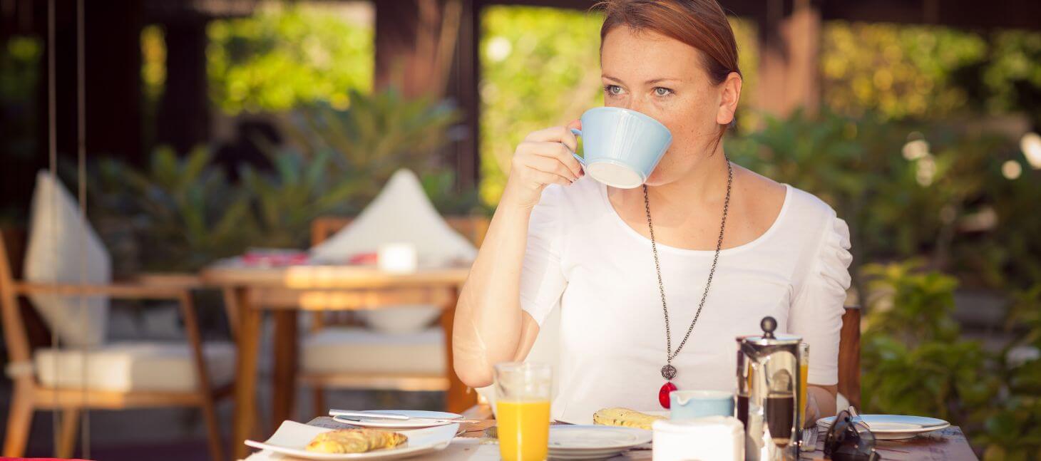 woman having breakfast outside