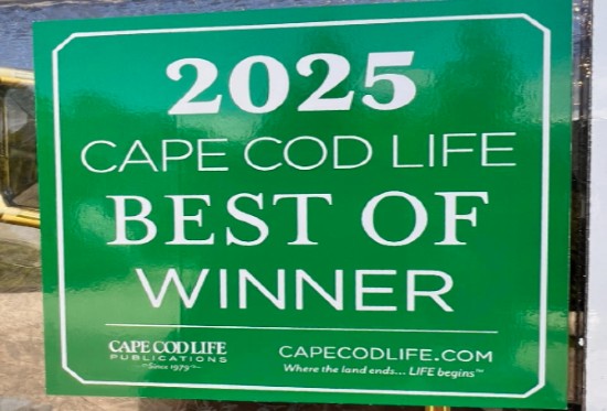 Green metal sign with white words for award stating "2025 Cape Cod Life Best of Winner"